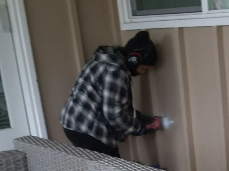 Professional electrician installing an exterior outlet in Red Hook